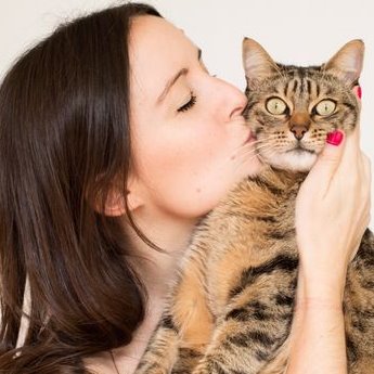 Cat lover kissing a cat